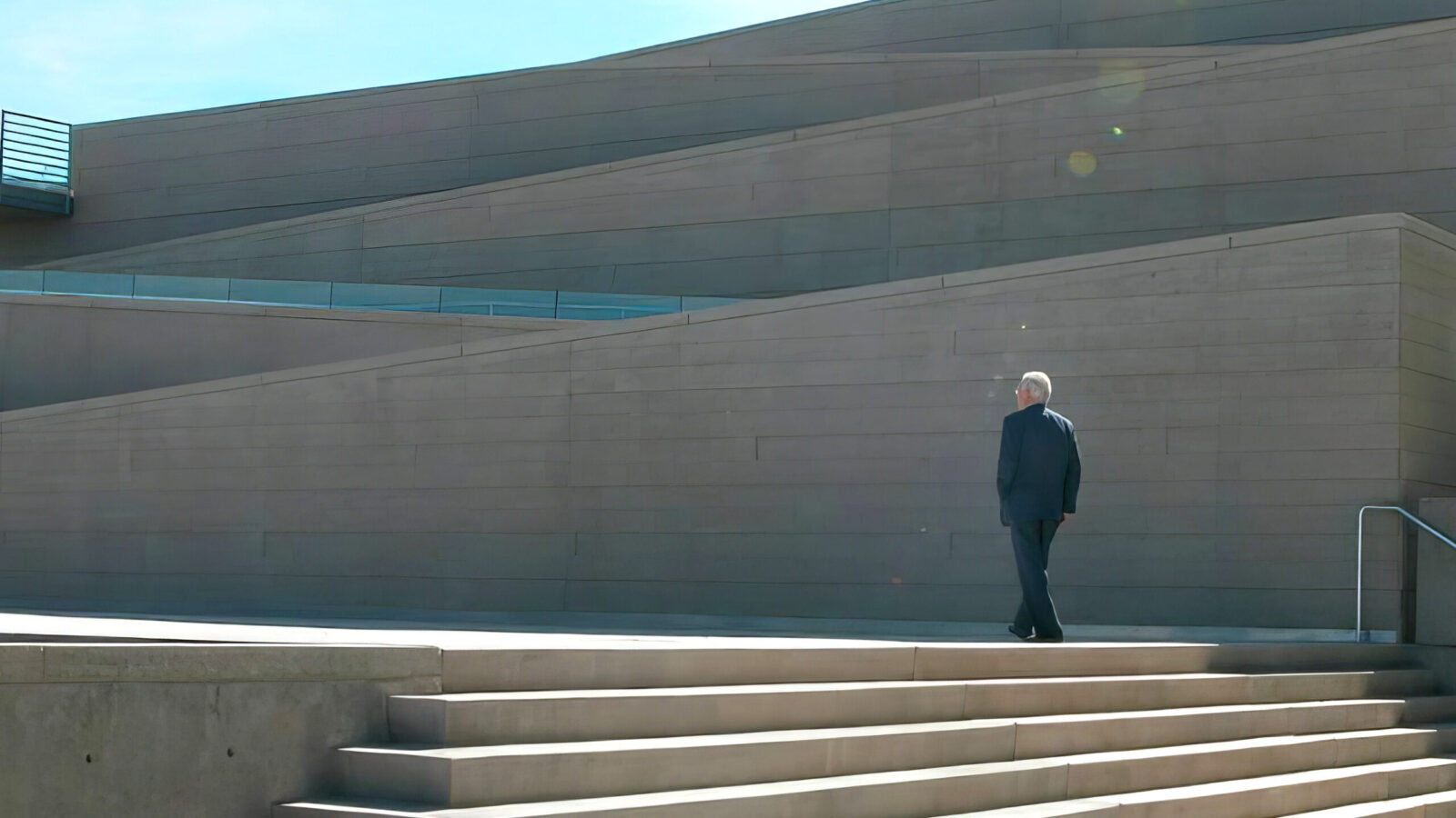 Arthur Erickson film still showing Erickson walking up stairs. ADFF Human/naTURE