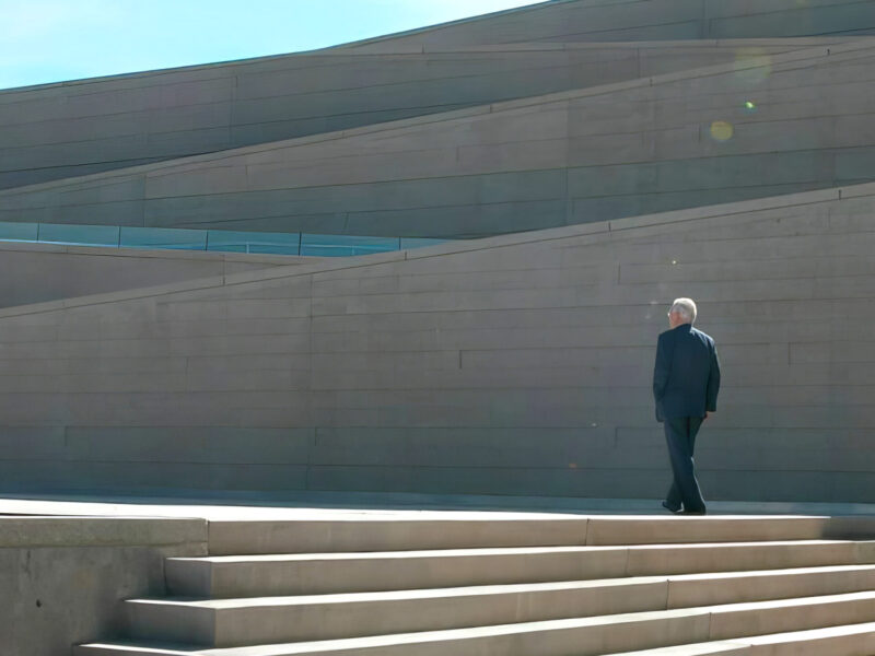 Arthur Erickson film still showing Erickson walking up stairs. ADFF Human/naTURE