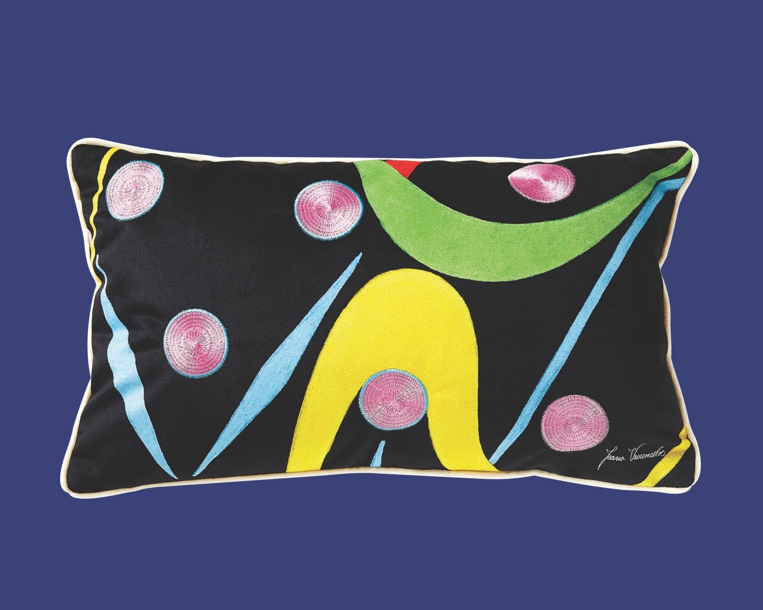 One of Azure's top gifts for designers from our 2024 guide is this patterned pillow featuring pink polka dots and colourful swooshes on a black background.