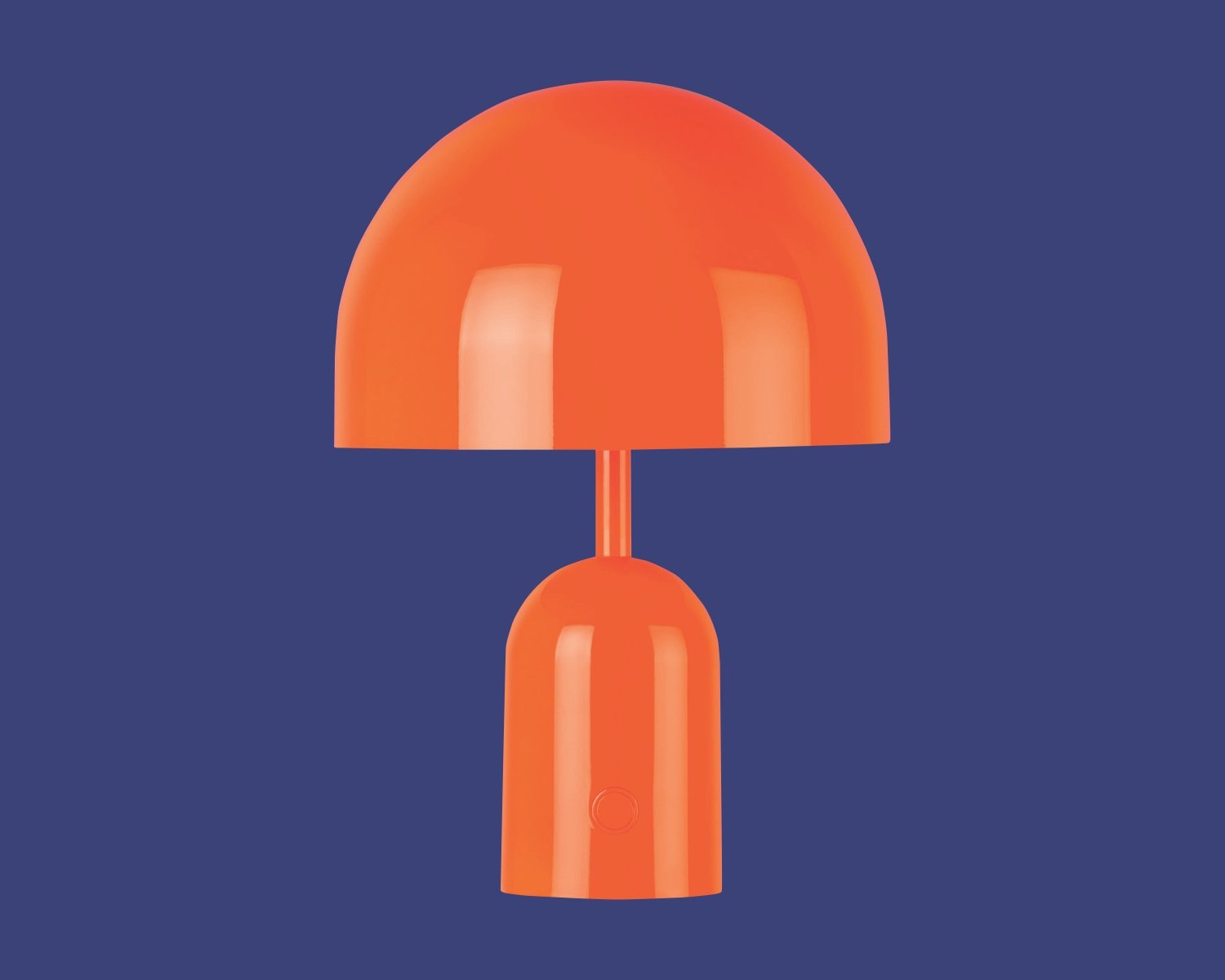 One of Azure's top gifts for designers from our 2024 guide is this orange lamp by Tom Dixon featuring a domed top resting on a cylindrical base.