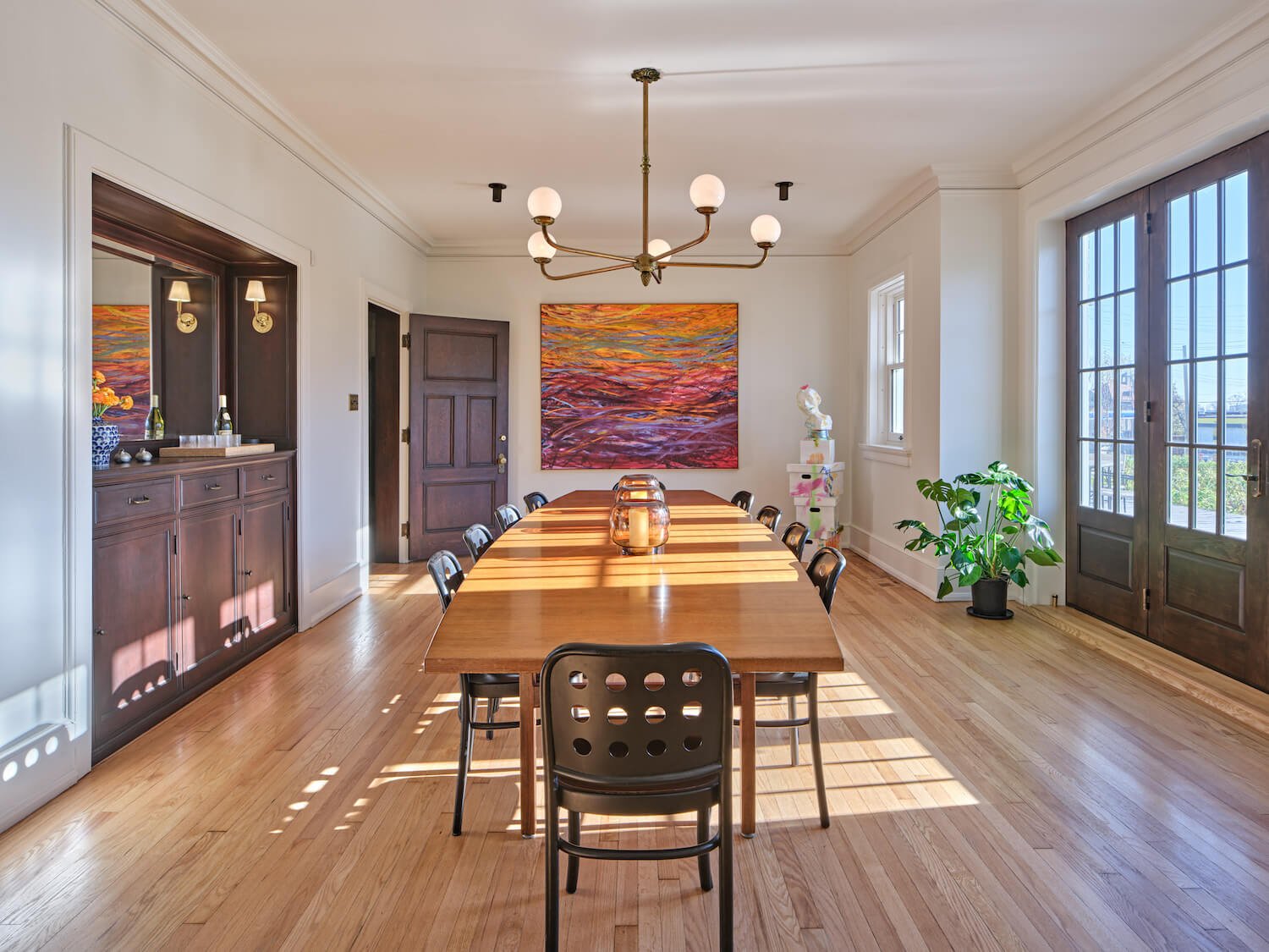 Inside the former rectory house, the ALEO bed and breakfast is distinguished by its large communal space and eclectic art program. View of communal dining table at ALEO, surrounded by works of art.