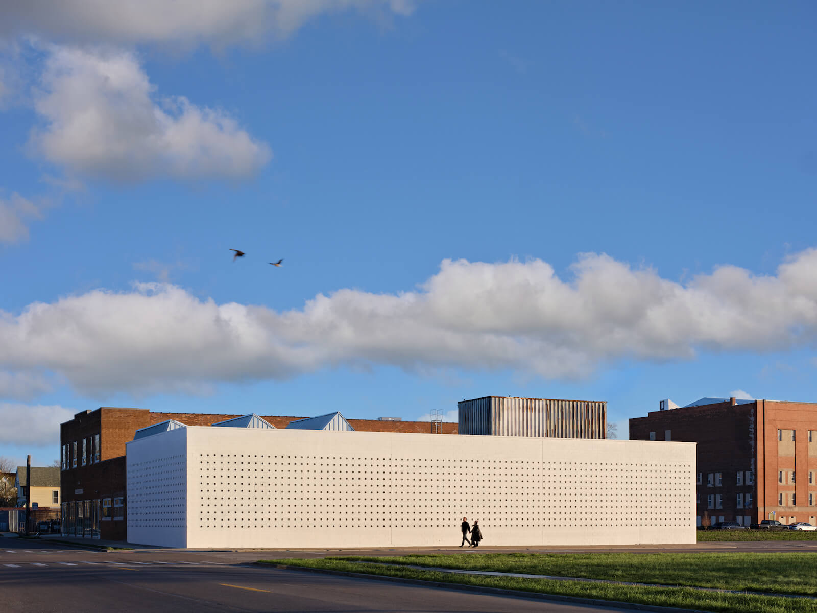 Up close, the monolithic white form dissolves into a simple array of perforated cinder blocks.