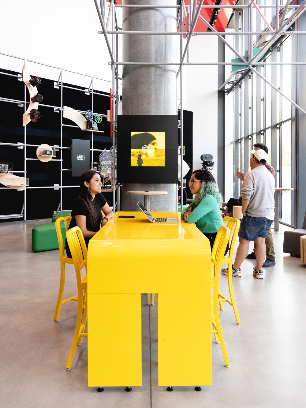 A close-up look at the bright yellow high table, with matching chairs