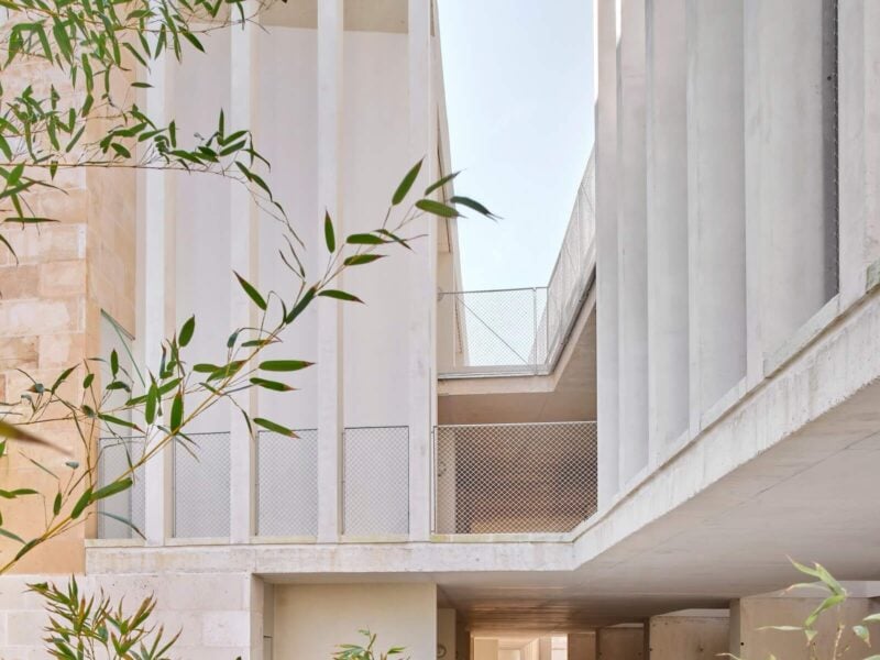 On the upper levels of Peris+Toral's housing in Son Servera, the common streets are delineated with vertical slats coupled with metal mesh barriers. The walkways are finished with cork ETICS clad in lime plaster.