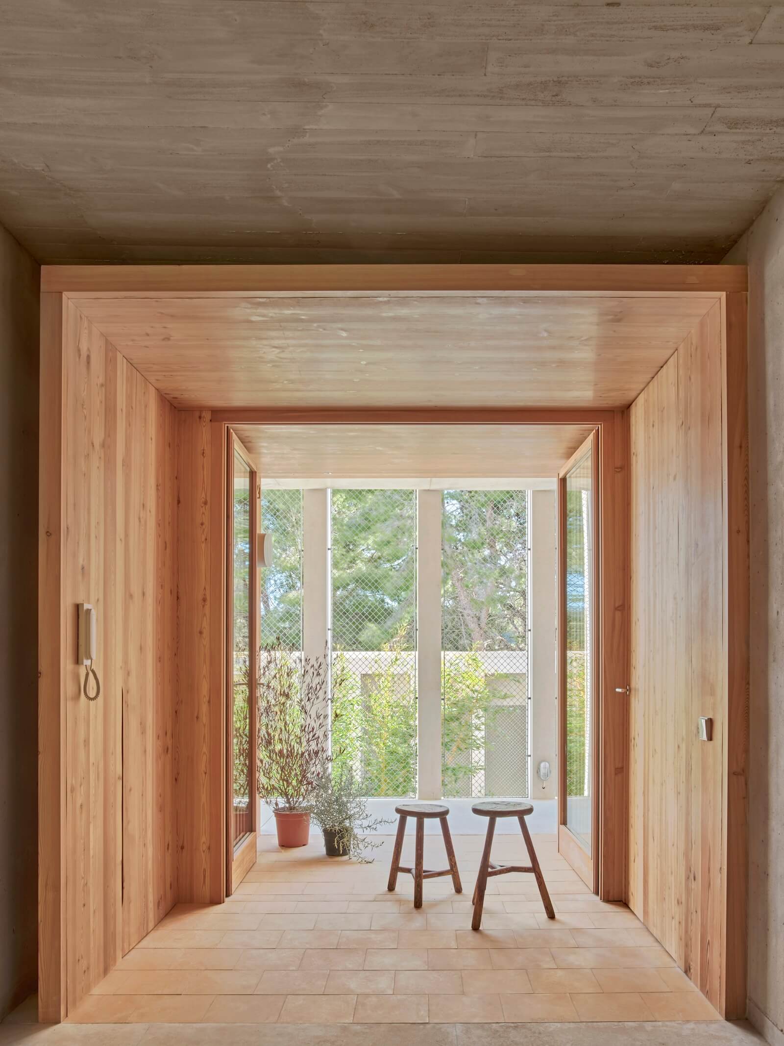 The residences of Peris+Toral's Son Servera project are accessed via indoor–outdoor wooden “lattices” that extend out to the walkways, which the firm refers to as “common streets.”