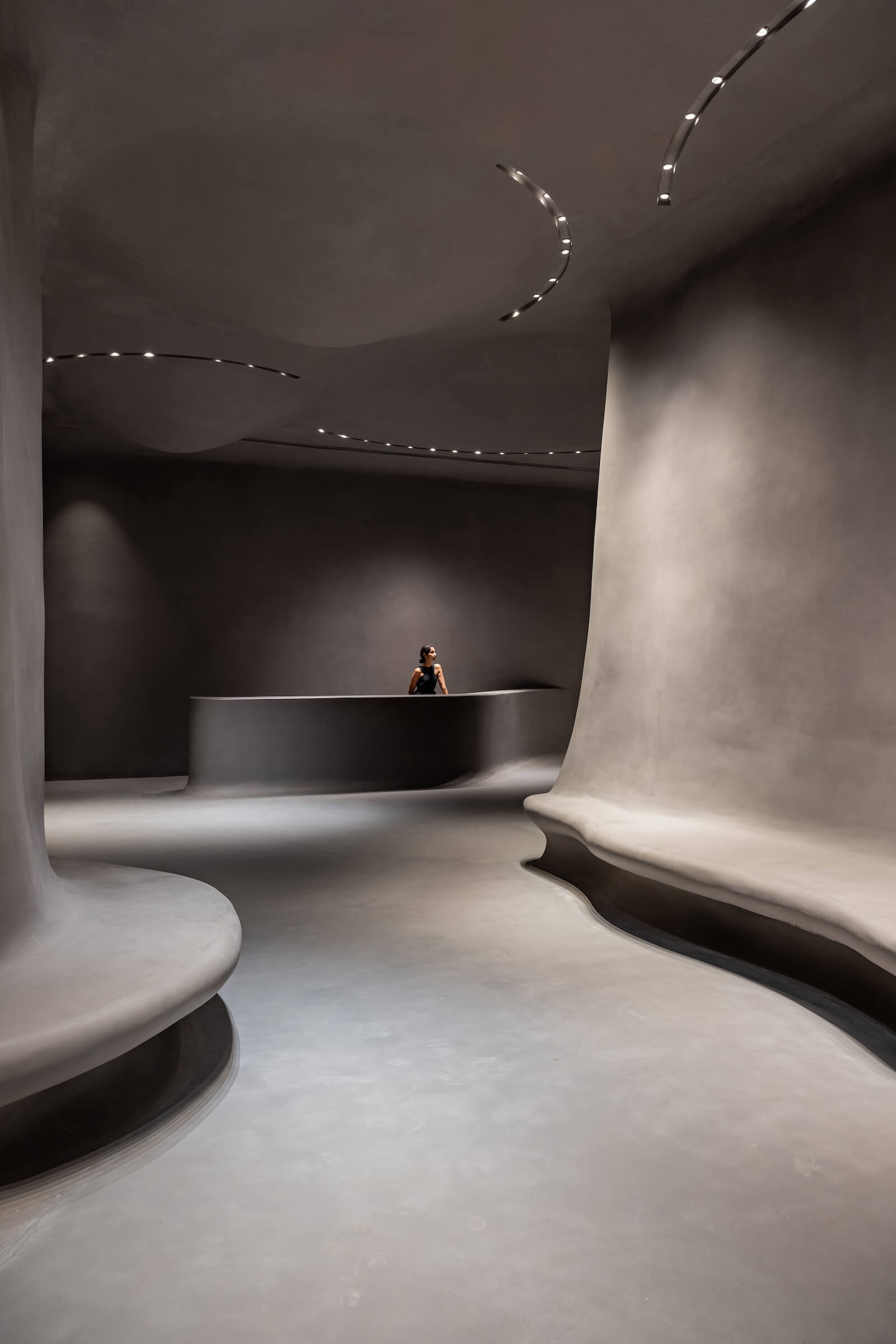 Sanjay Puri's Aatma Manthan Museum features a sinuous entrance interior in all grey.