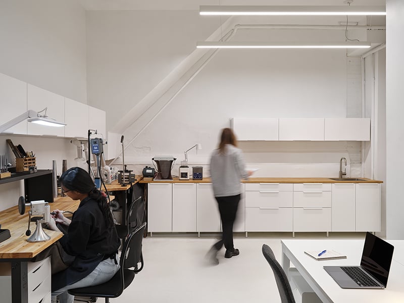 The working side of the shop, tucked behind a pair of partitions, features a “golden triangle kitchen” set-up.