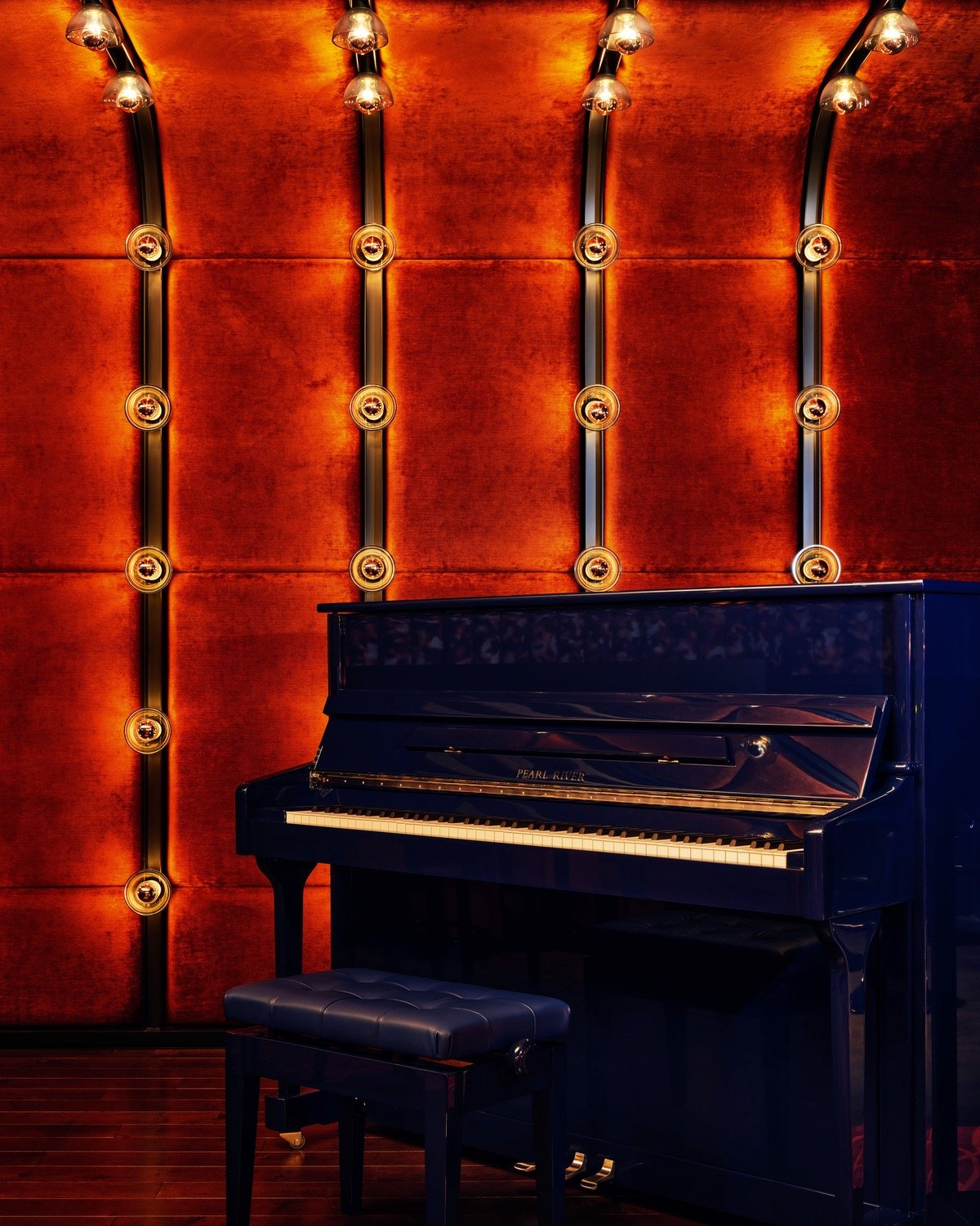 A blue piano sits in front of a red upholstered wall with rows of light bulbs running up the wall.