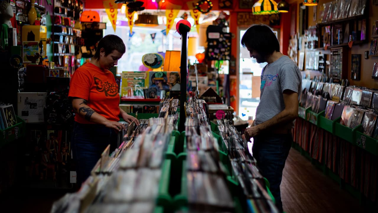 Customer browsing albums at The Electric Kitsch Record Store in Bay City, Michigan